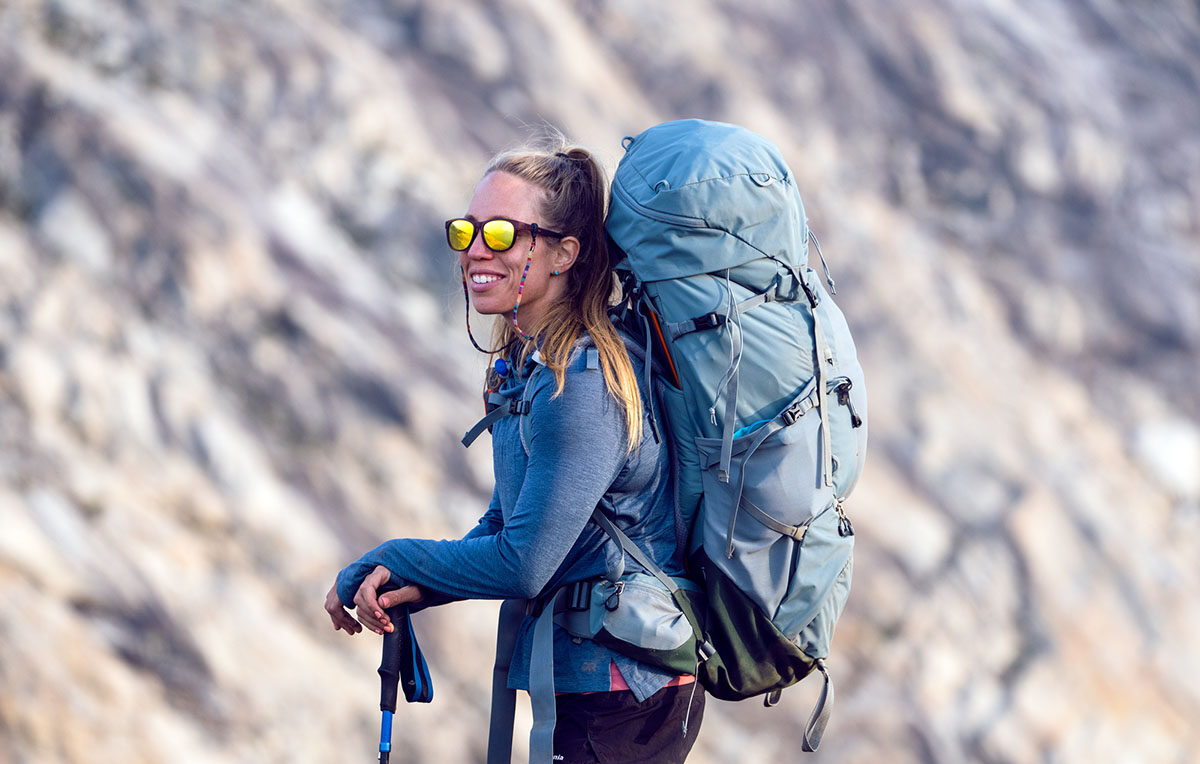 Womens backpacking pack standing in mountains with Deuter Aircontact Core e1744107843395 تصویر Womens backpacking pack standing in mountains with Deuter Aircontact Core e1744107843395